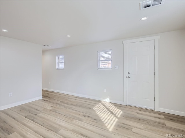 interior space featuring baseboards, a wealth of natural light, and visible vents