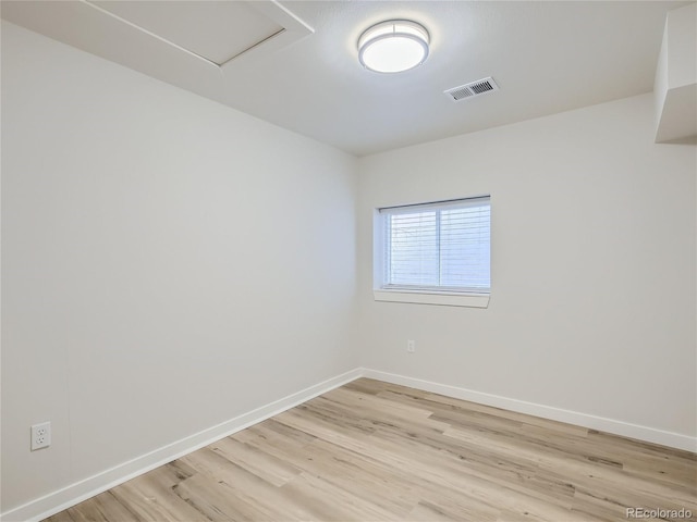 empty room with baseboards, visible vents, and light wood-style flooring