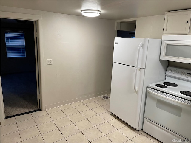 kitchen featuring baseboards, white cabinetry, light tile patterned floors, and white appliances