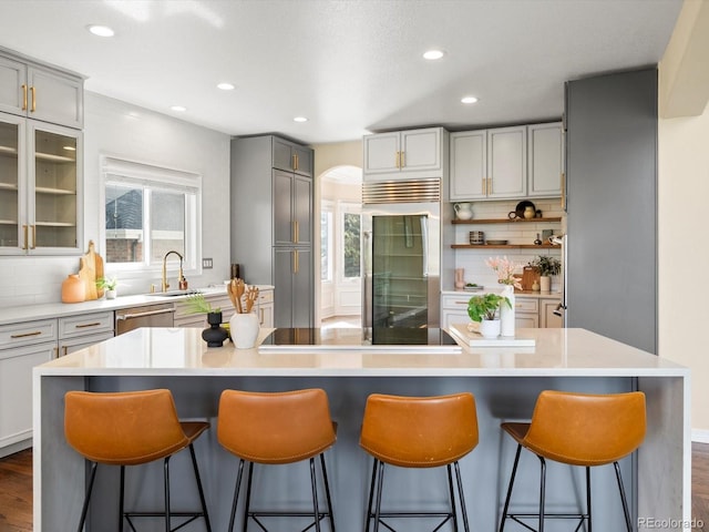 8425 Green Island Cir, Lone Tree, CO 80124 - kitchen with built in refrigerator, gray cabinets, decorative backsplash, healthy amount of natural light, and recessed lighting