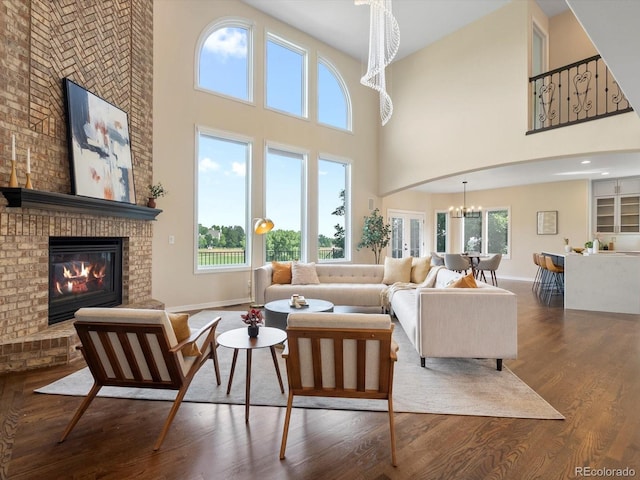 8425 Green Island Cir, Lone Tree, CO 80124 - living area with a chandelier, a high ceiling, wood finished floors, and a fireplace