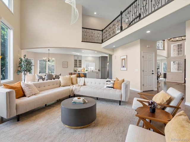 8425 Green Island Cir, Lone Tree, CO 80124 - living area with a high ceiling, a chandelier, arched walkways, plenty of natural light, and recessed lighting