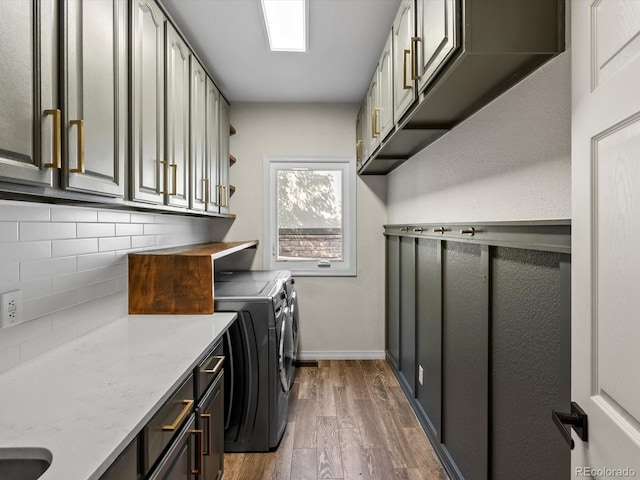 8425 Green Island Cir, Lone Tree, CO 80124 - laundry room featuring washing machine and clothes dryer, wood finished floors, and cabinet space