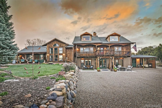 24857 US Highway 160, Walsenburg, CO 81089 - back of house featuring a patio, a chimney, french doors, a lawn, and a wooden deck