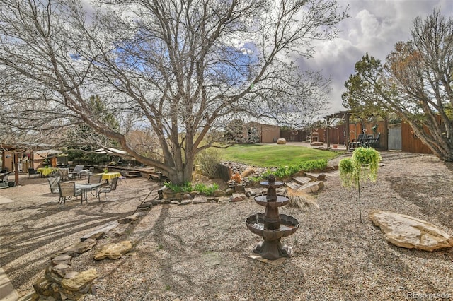 24857 US Highway 160, Walsenburg, CO 81089 - view of green lawn featuring a patio area, a storage shed, and an outbuilding