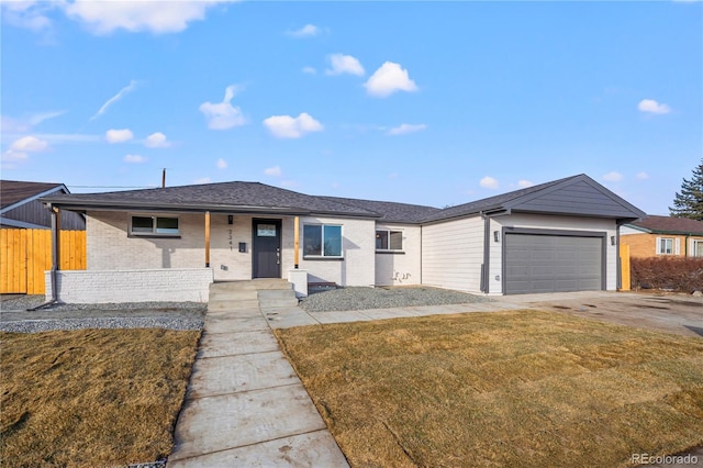 ranch-style home with a garage and a front yard