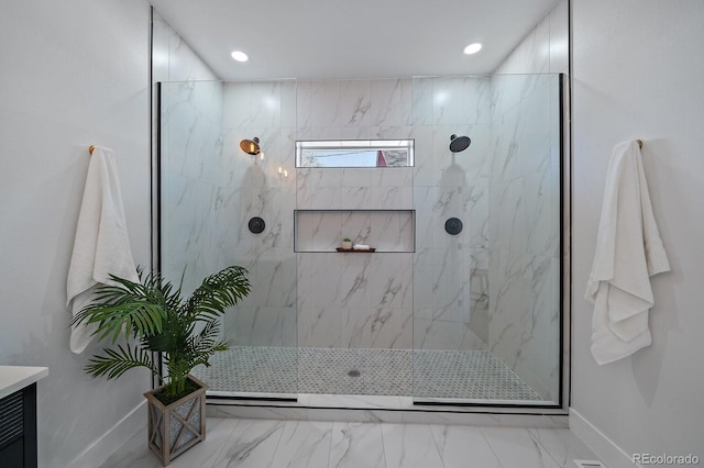 bathroom featuring a tile shower and vanity