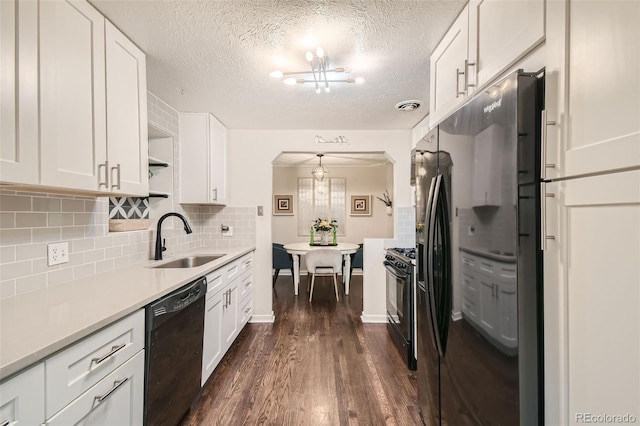 kitchen with white cabinets, sink, black appliances, and dark hardwood / wood-style flooring