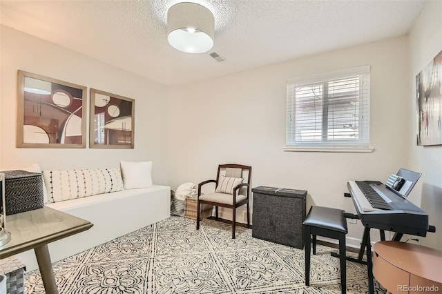 tiled living room with a textured ceiling