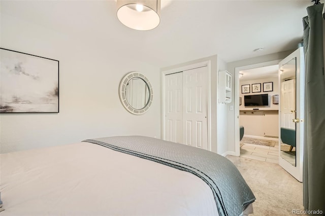 bedroom with light colored carpet and a closet