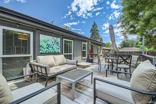 wooden terrace featuring a patio and an outdoor hangout area