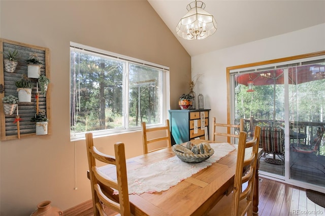 dining room featuring a chandelier, lofted ceiling, and wood-type flooring