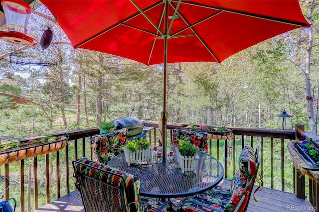 deck with a forest view and a grill