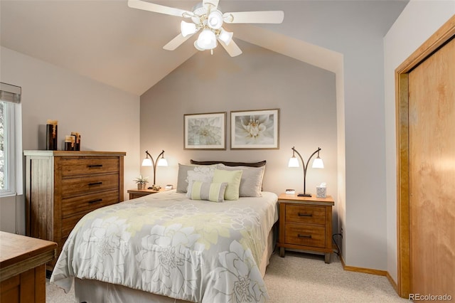 bedroom with light colored carpet, ceiling fan, baseboards, and vaulted ceiling