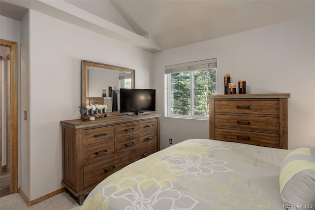 bedroom with baseboards, lofted ceiling, and carpet