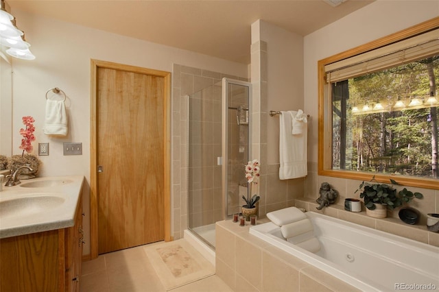 full bath with a sink, a bath, a shower stall, and tile patterned flooring