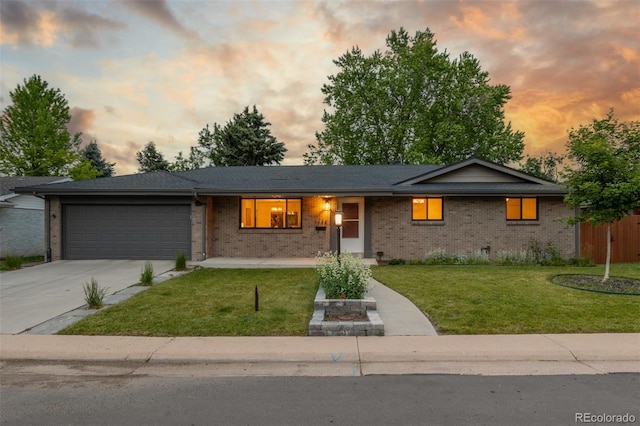 2644 S Krameria St, Denver, CO 80222 - ranch-style house with brick siding, a garage, and a front yard