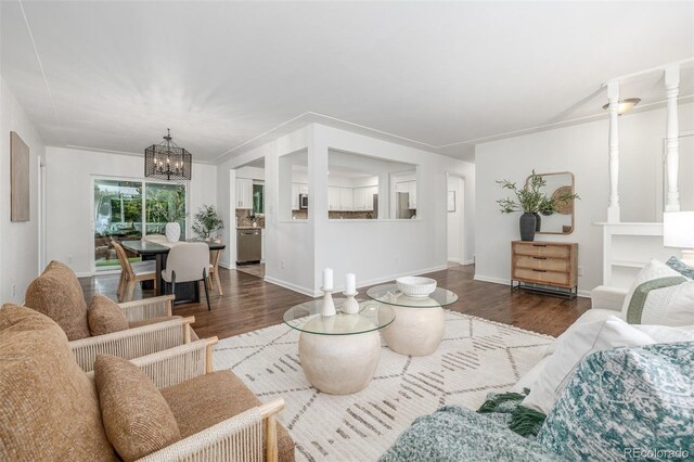 2644 S Krameria St, Denver, CO 80222 - living room with wood finished floors, a chandelier, and baseboards