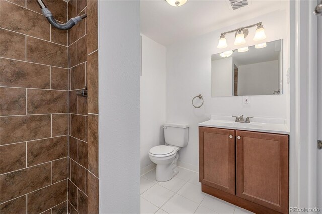 2644 S Krameria St, Denver, CO 80222 - bathroom featuring a tile shower, vanity, toilet, tile patterned floors, and baseboards