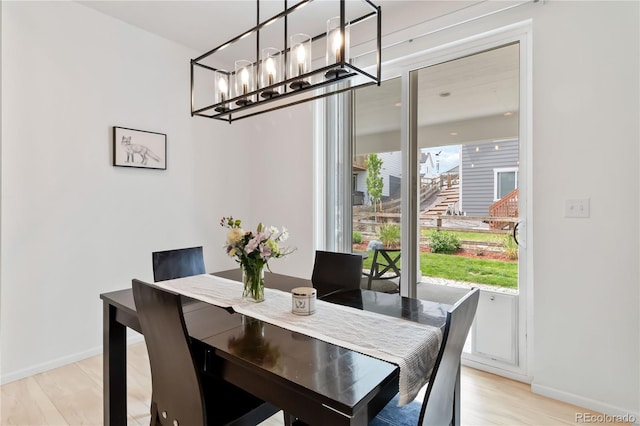 1369 E Witherspoon Dr, Elizabeth, CO 80107 - dining space featuring baseboards, light wood-style flooring, and a chandelier
