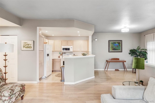 kitchen featuring light hardwood / wood-style floors and white appliances