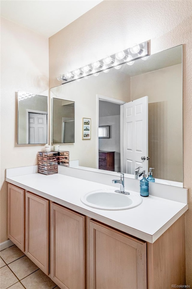 bathroom featuring tile patterned floors and vanity