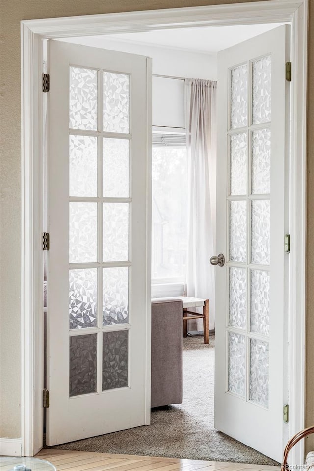 doorway featuring light colored carpet