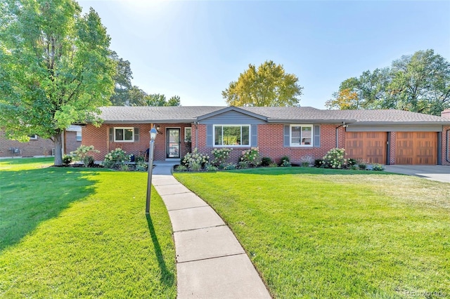 ranch-style house featuring a garage and a front lawn