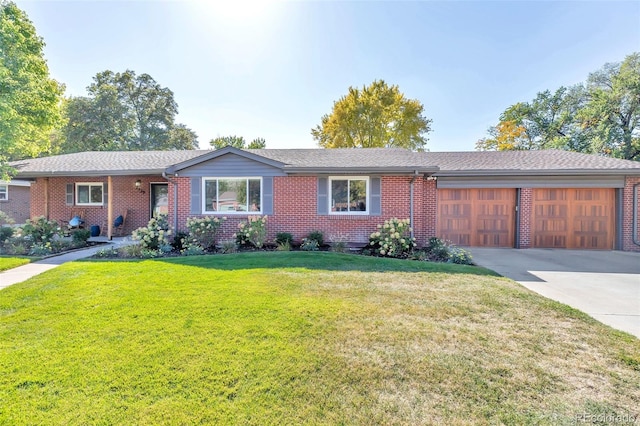 ranch-style home featuring a front lawn, brick siding, and an attached garage