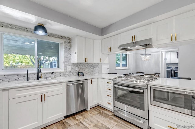 kitchen featuring white cabinetry, stainless steel appliances, and sink