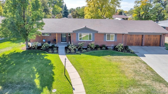 ranch-style home with a garage and a front lawn