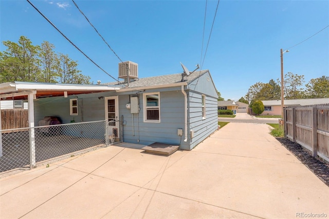 7291 Bryant St, Westminster, CO 80030 - back of house with central AC unit, a patio, driveway, and a shingled roof