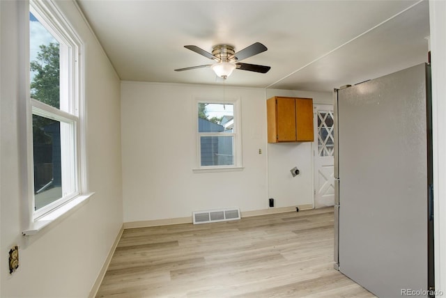 7291 Bryant St, Westminster, CO 80030 - laundry area with cabinet space, a ceiling fan, and light wood finished floors