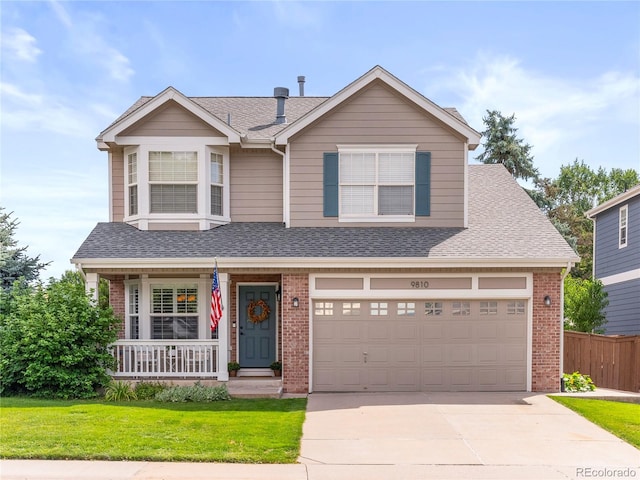 traditional-style home featuring brick siding, roof with shingles, covered porch, concrete driveway, and a front yard