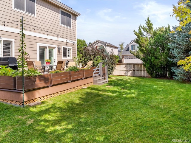 view of yard featuring fence and a wooden deck