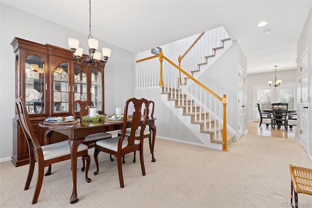 carpeted dining area featuring baseboards, stairway, recessed lighting, and a notable chandelier