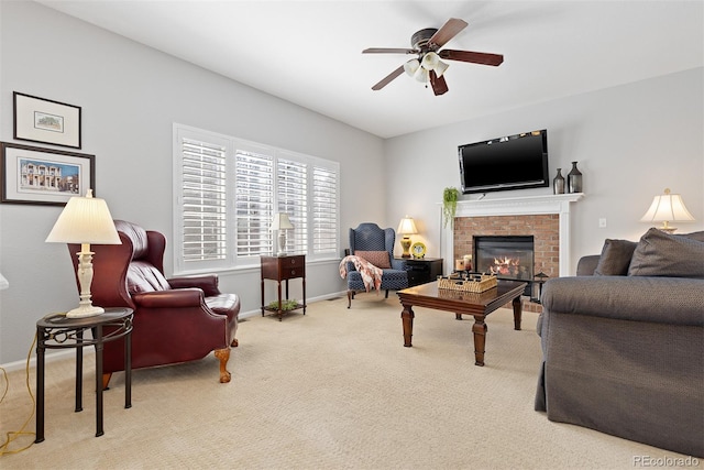 living room featuring baseboards, a fireplace, a ceiling fan, and carpet flooring