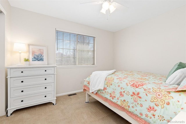 bedroom featuring a ceiling fan, light carpet, visible vents, and baseboards