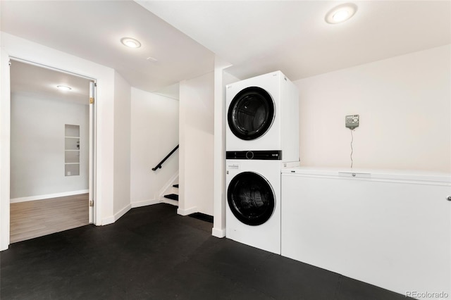 laundry room with stacked washer / dryer