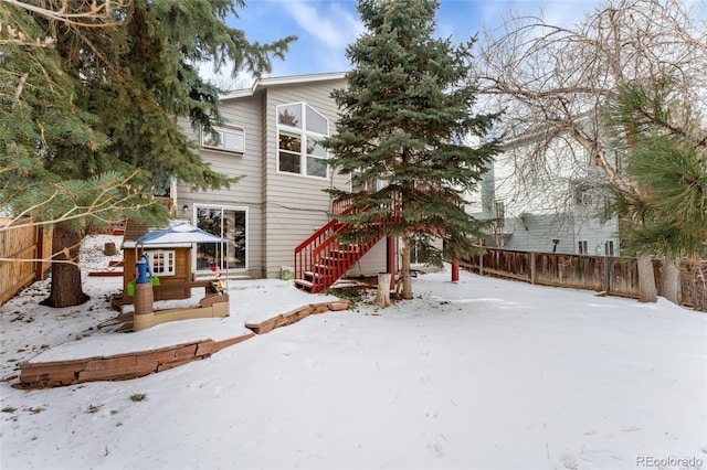 view of snow covered rear of property