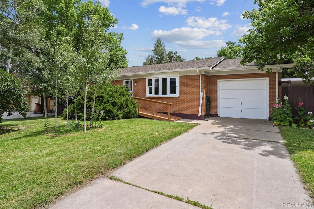940 Nile St, Golden, CO 80401 - ranch-style house featuring a garage, brick siding, a front yard, concrete driveway, and roof with shingles