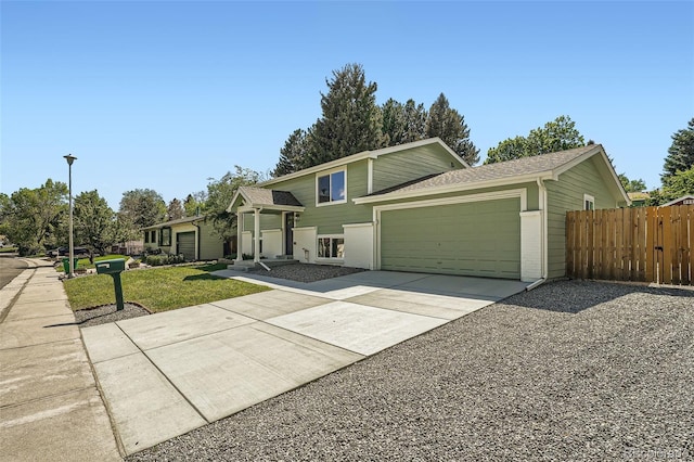 1183 S Pierson Ct, Denver, CO 80232 - tri-level home featuring driveway, an attached garage, and a shingled roof