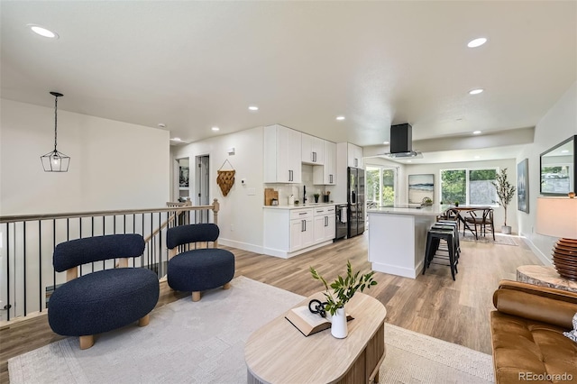 1183 S Pierson Ct, Denver, CO 80232 - living area with light wood-style flooring, recessed lighting, and baseboards