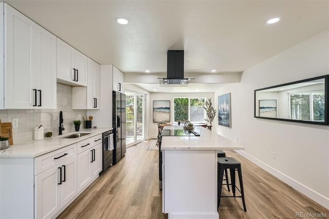 1183 S Pierson Ct, Denver, CO 80232 - kitchen featuring a sink, a center island, island range hood, dishwasher, and black fridge with ice dispenser