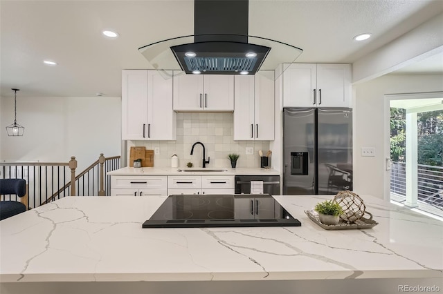 1183 S Pierson Ct, Denver, CO 80232 - kitchen featuring stainless steel fridge, island exhaust hood, a sink, stovetop, and white cabinets
