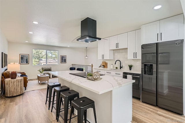 1183 S Pierson Ct, Denver, CO 80232 - kitchen with stainless steel fridge with ice dispenser, a kitchen bar, light stone counters, extractor fan, and recessed lighting
