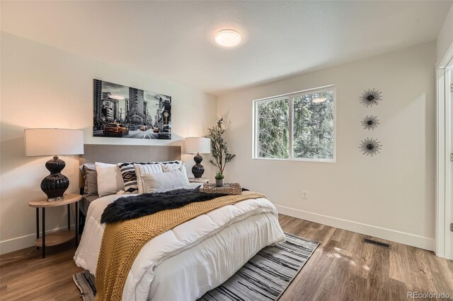 1183 S Pierson Ct, Denver, CO 80232 - bedroom with baseboards and wood finished floors