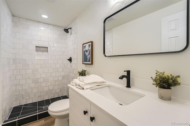 1183 S Pierson Ct, Denver, CO 80232 - full bath featuring a tile shower, vanity, toilet, recessed lighting, and wood finished floors