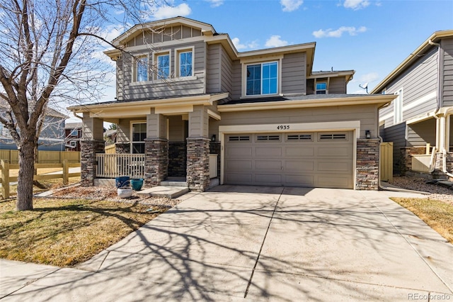 craftsman-style home with board and batten siding, concrete driveway, covered porch, and stone siding