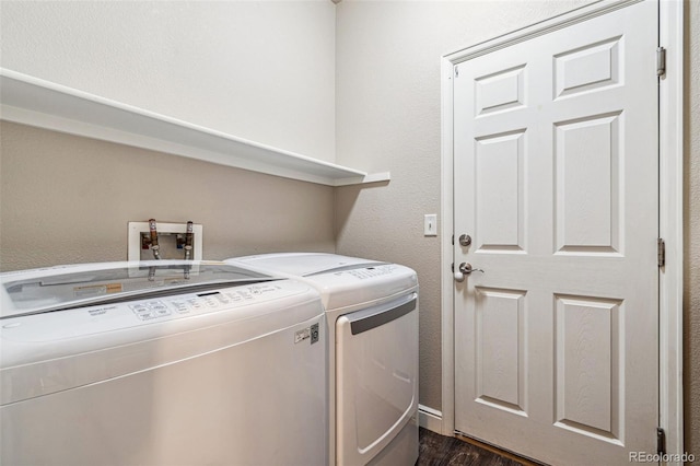 laundry area featuring dark wood-style floors, laundry area, and washing machine and dryer